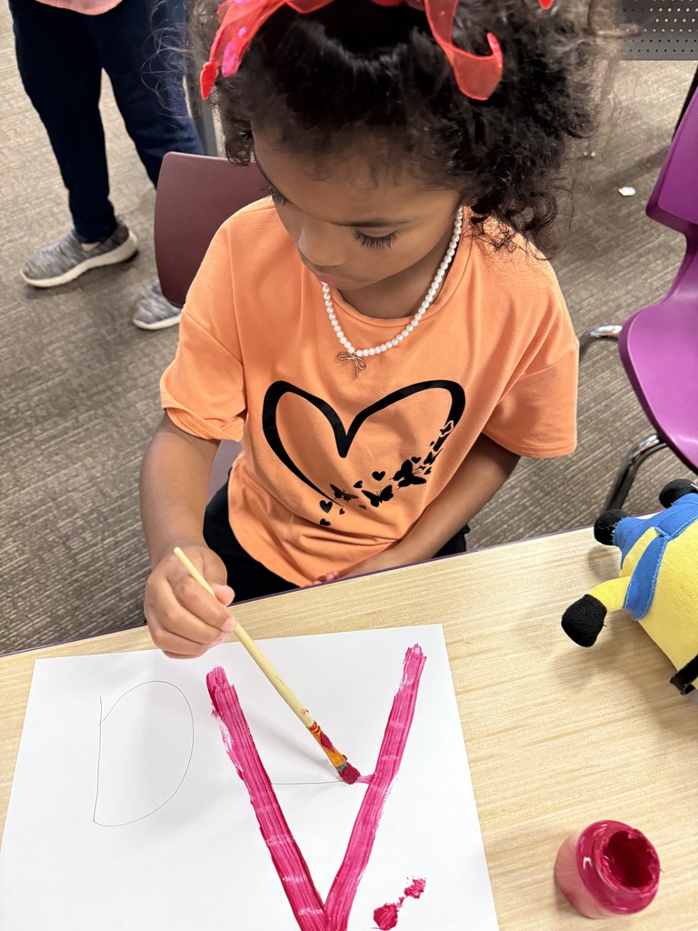 Student learning uppercase and lowercase “A” through painting