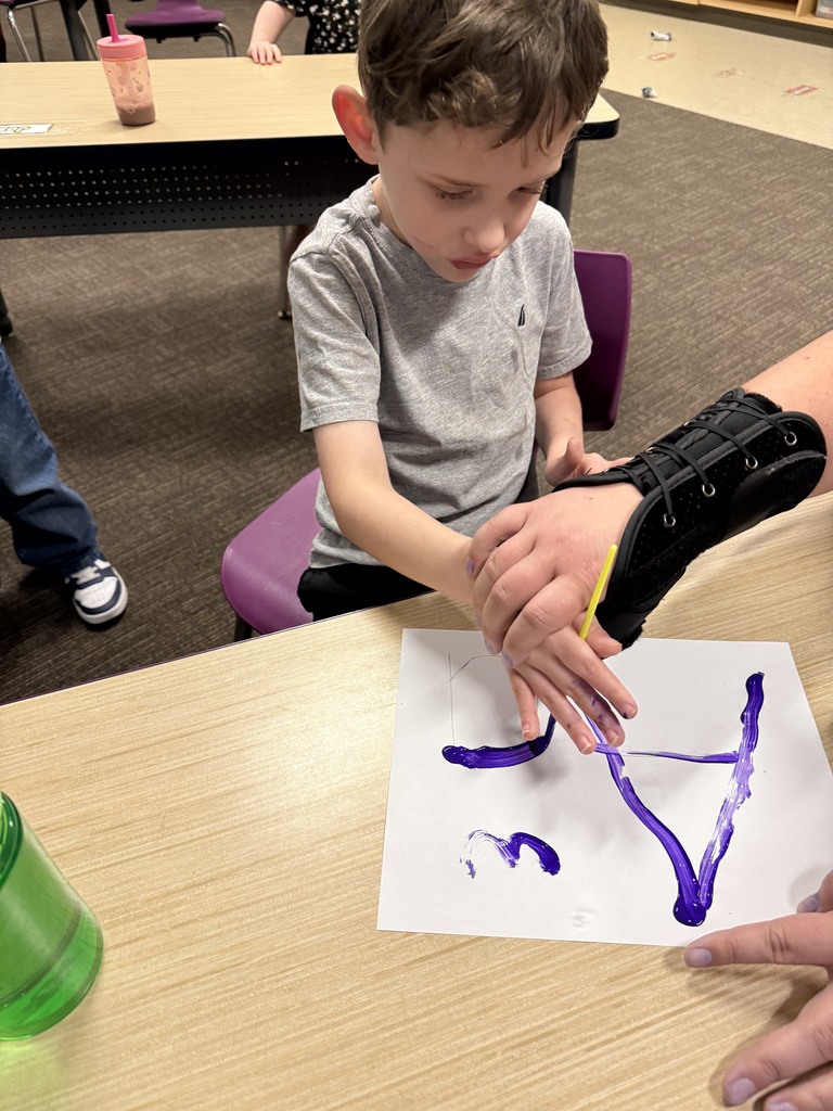 Student learning uppercase and lowercase “A” through painting
