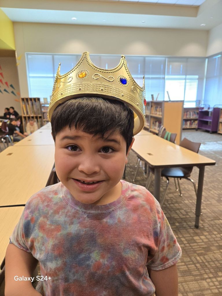 Sweet 1st grader having fun in the library. 