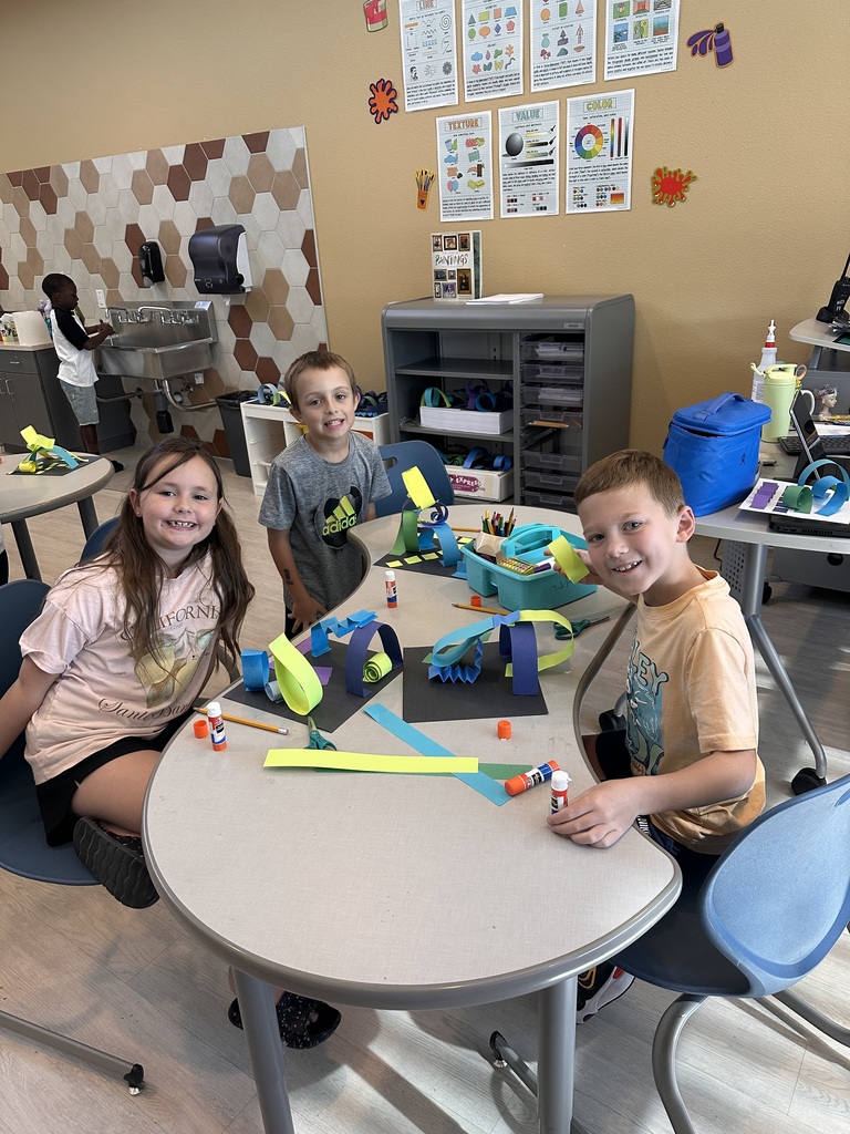 elementary students working diligently on their art creation