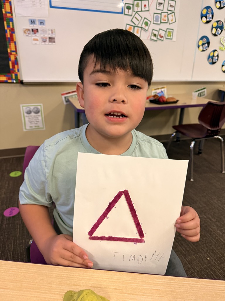 Student showing off his two dimensional shape.