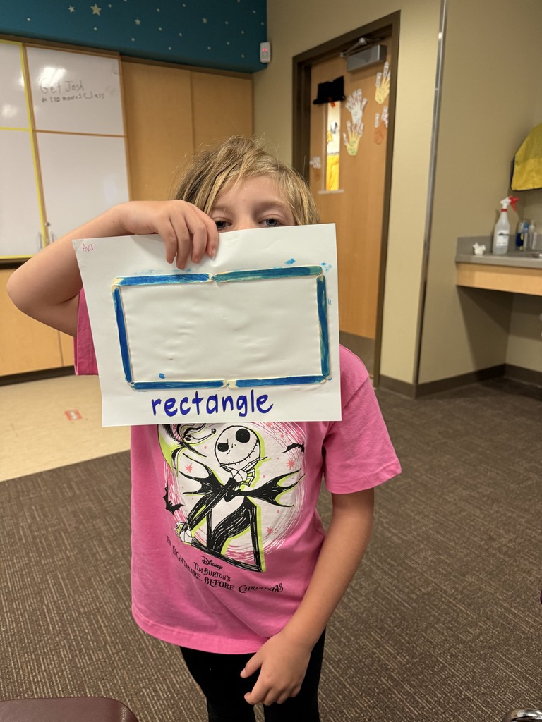 Student showing off her two dimensional shape.