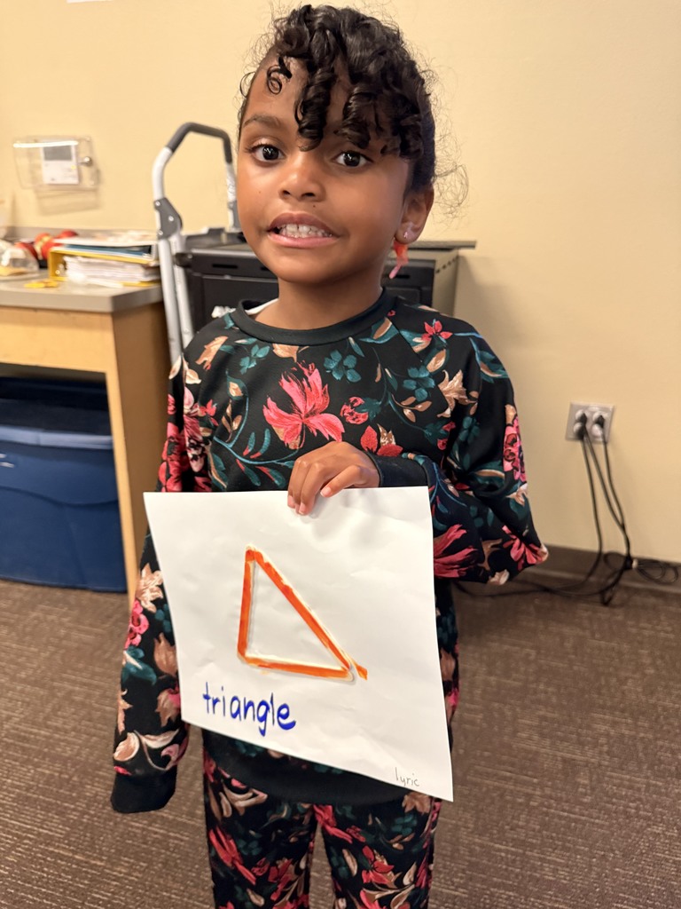 Student showing off her two dimensional shape.