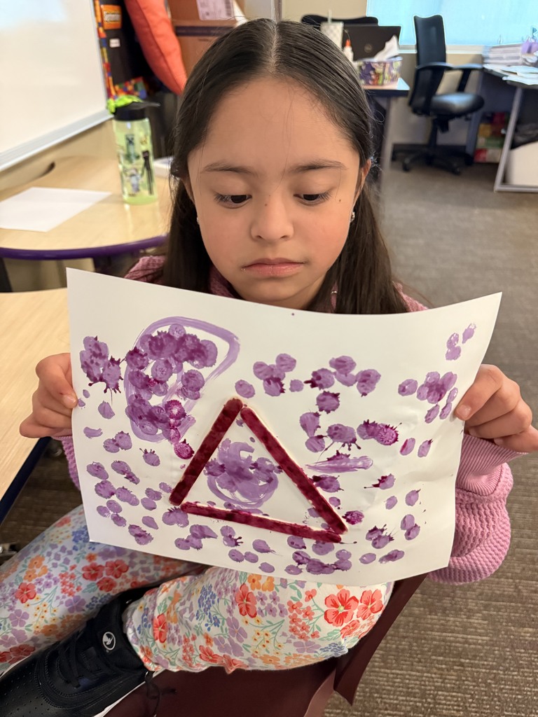 Student showing off her two dimensional shape.