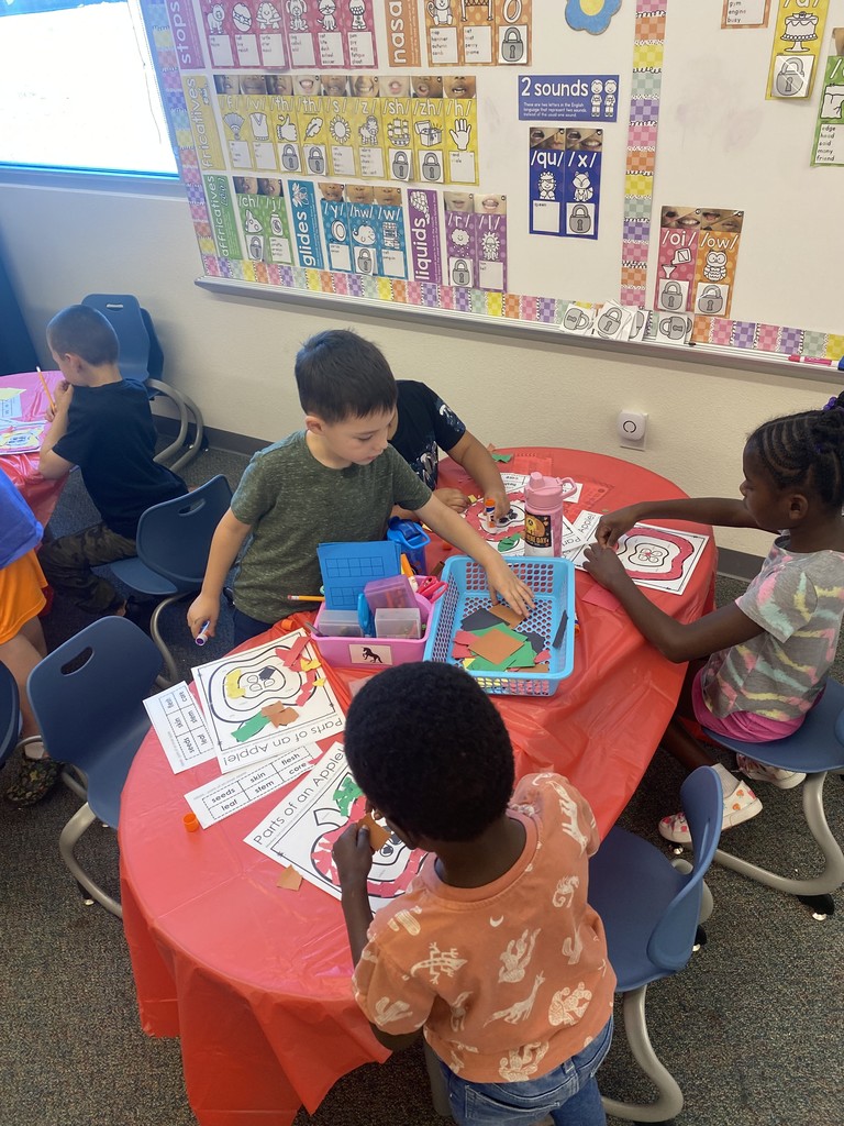 students working together on an apple craft