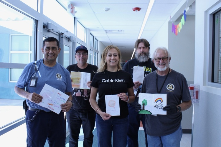 group of custodians with thank you cards