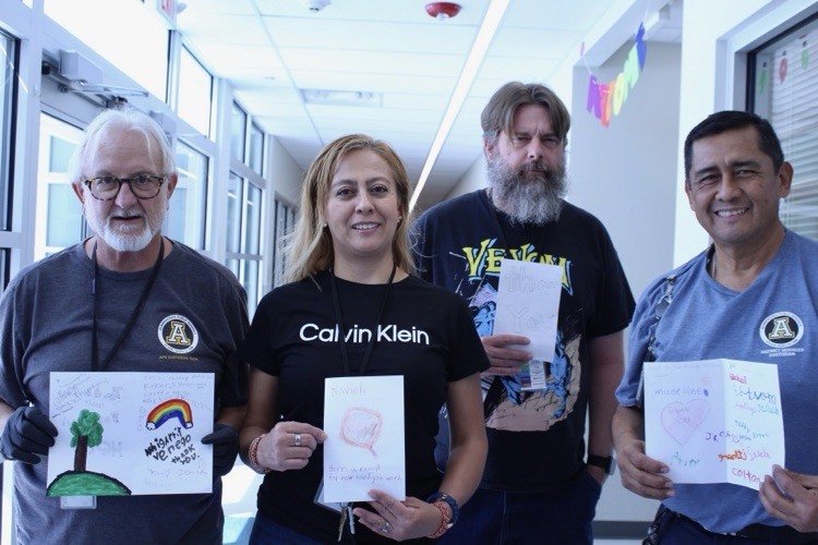 group of custodians with thank you cards