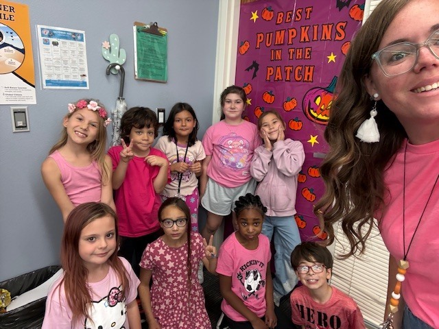 teacher and students wearing pink