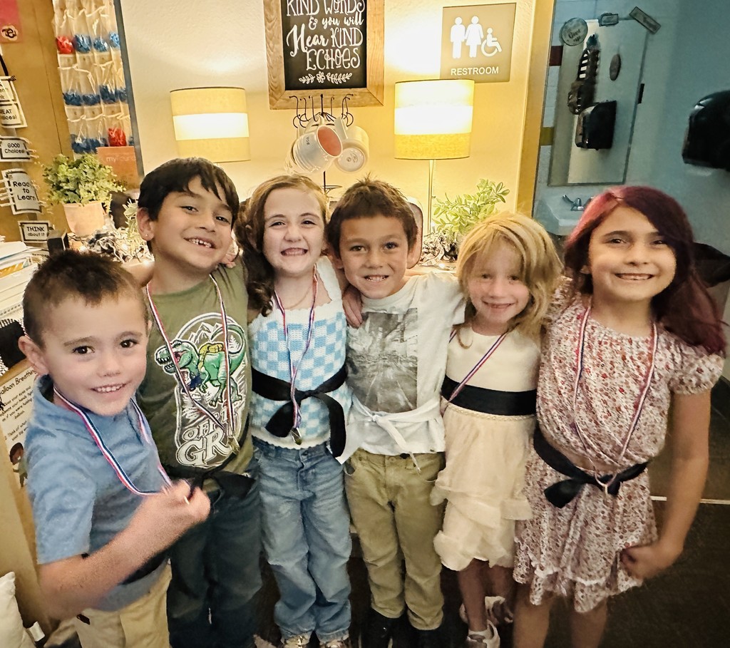 Students showing off their black and white belts.