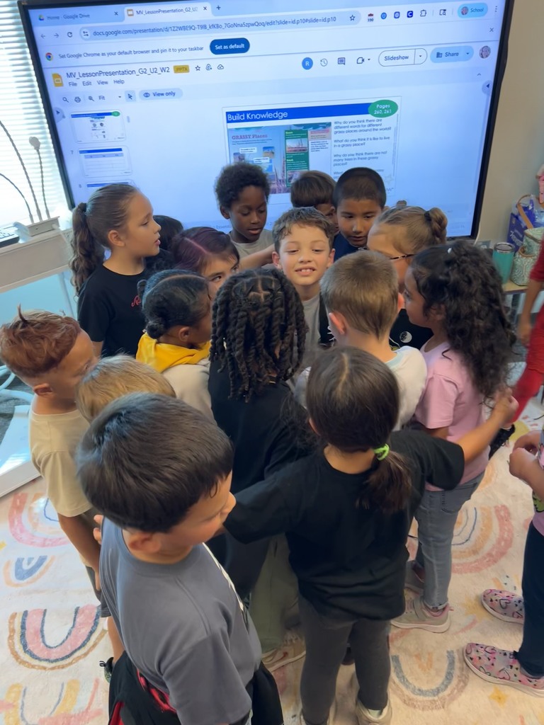 Ms. Mendoza's class giving a group hug to a student.