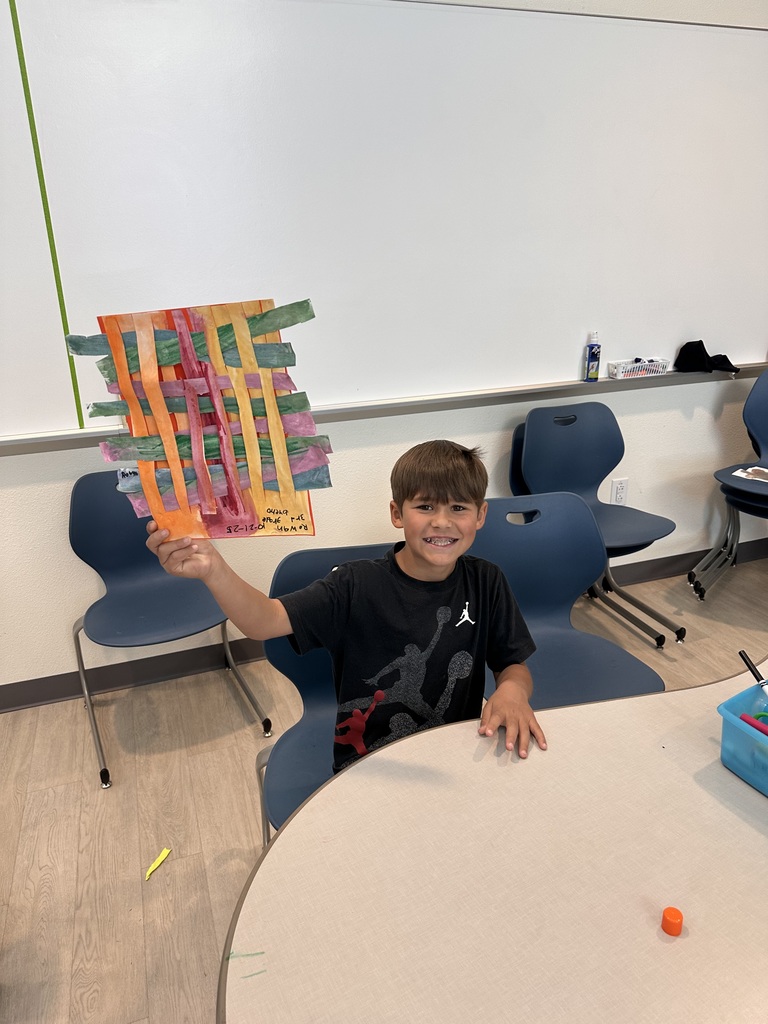 student proud of artwork