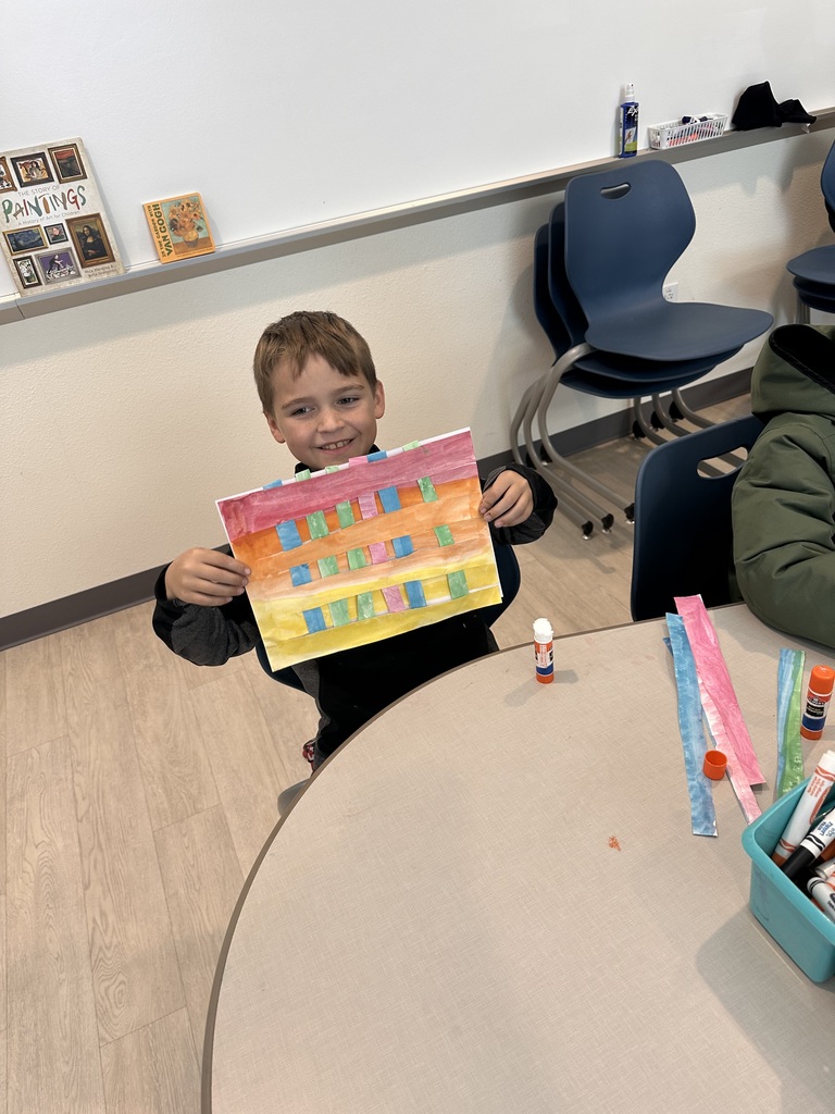 Student showing off artwork