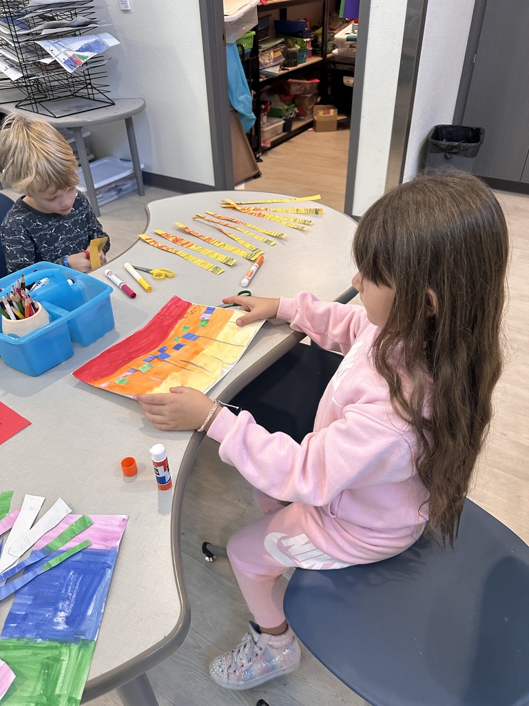 student reflecting on their artwork