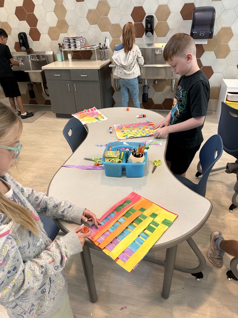 cutting and gluing different colored artwork