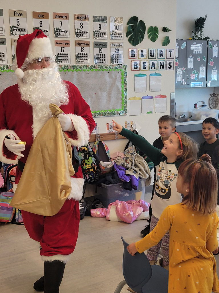 Santa and students spreading holiday cheer