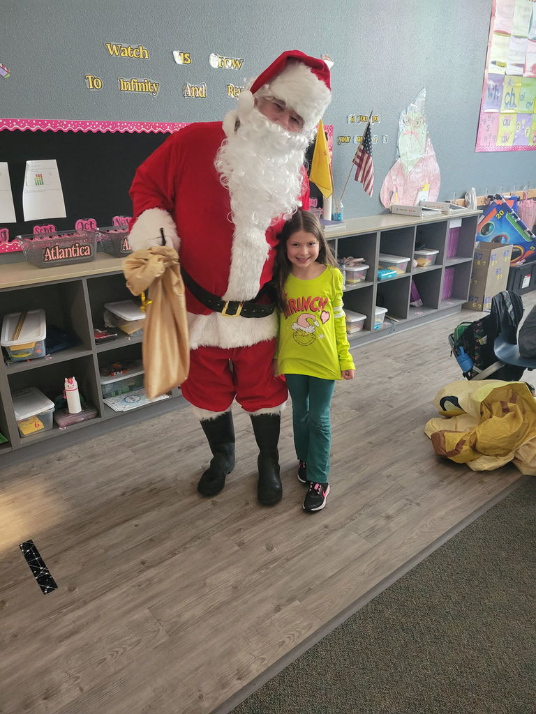 Santa Claus giving a hug to student