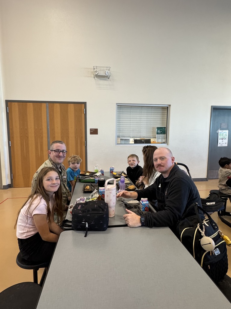 Family sharing thanksgiving lunch at school 