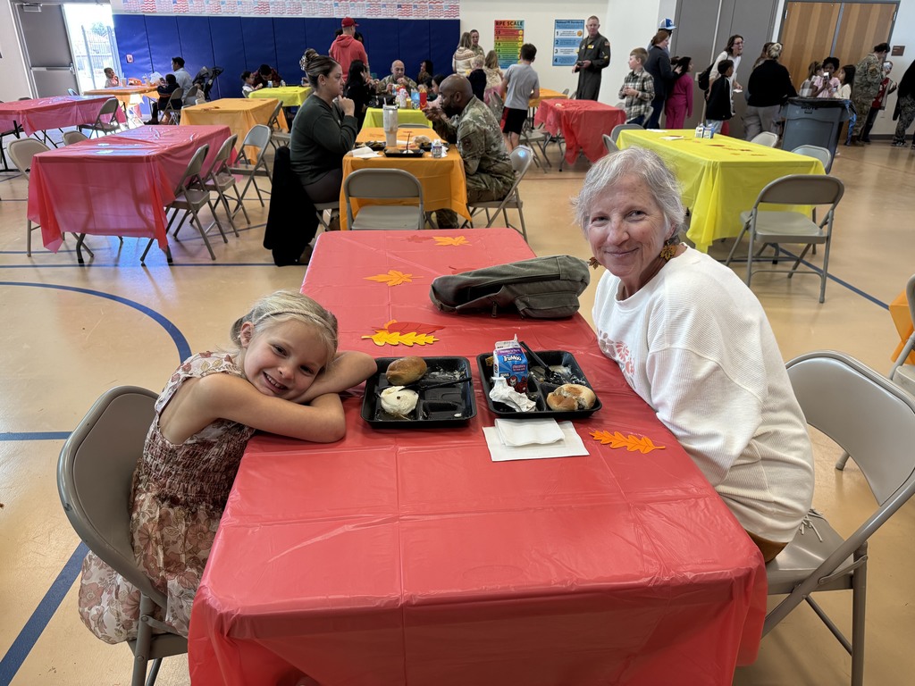 Student enjoying a meal with guardian