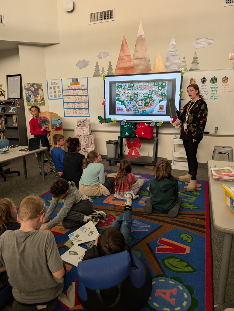 Teacher reminding students of what the goals are for their Lego League missions and how to get maximum amount of points.