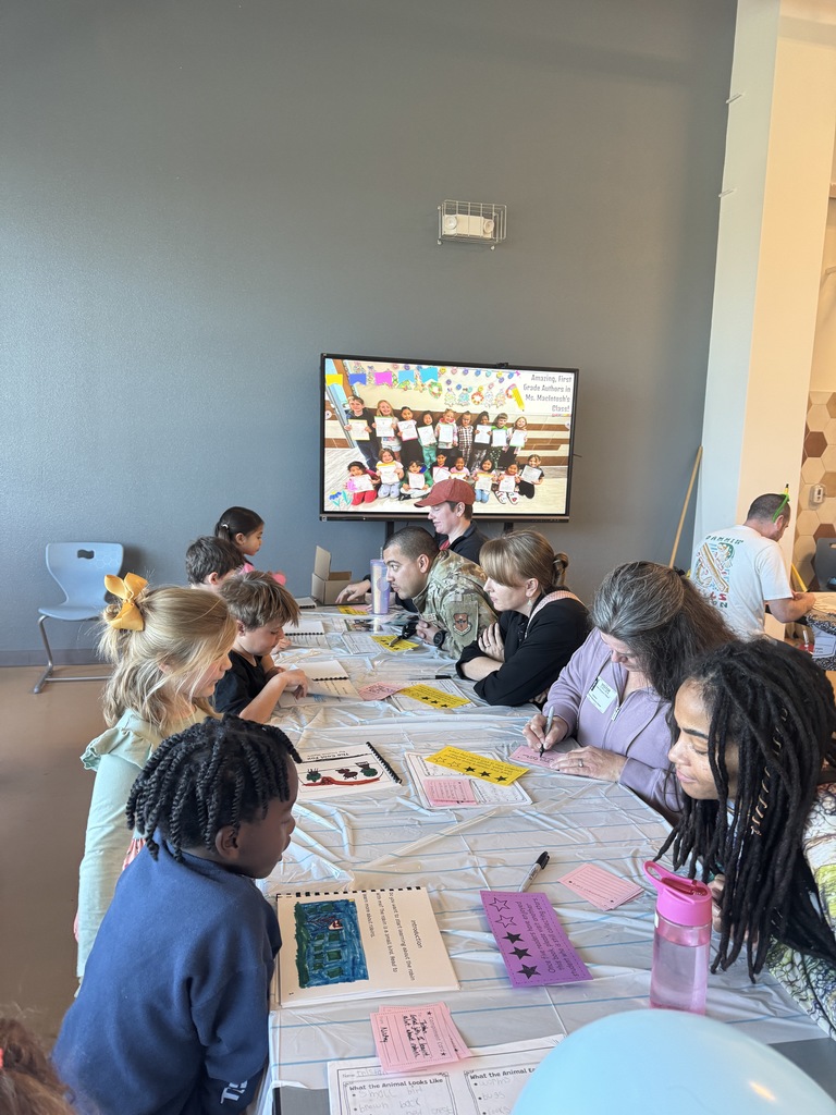 students and parents reviewing writing books 