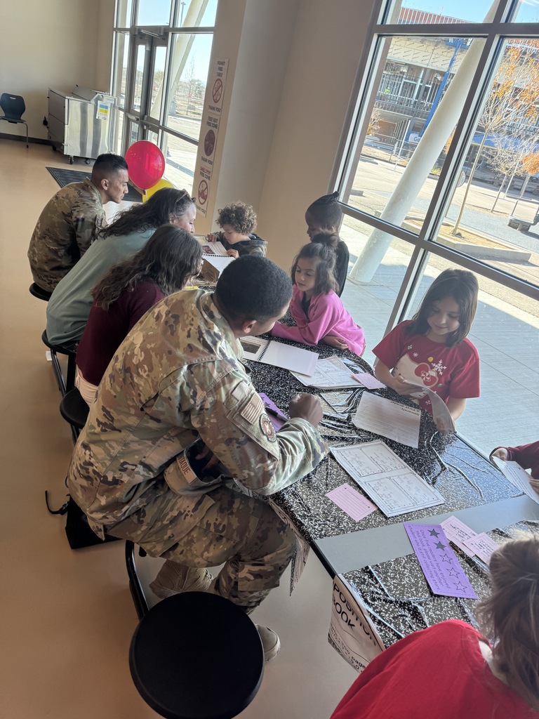 parents listening to their children read about their researched animal