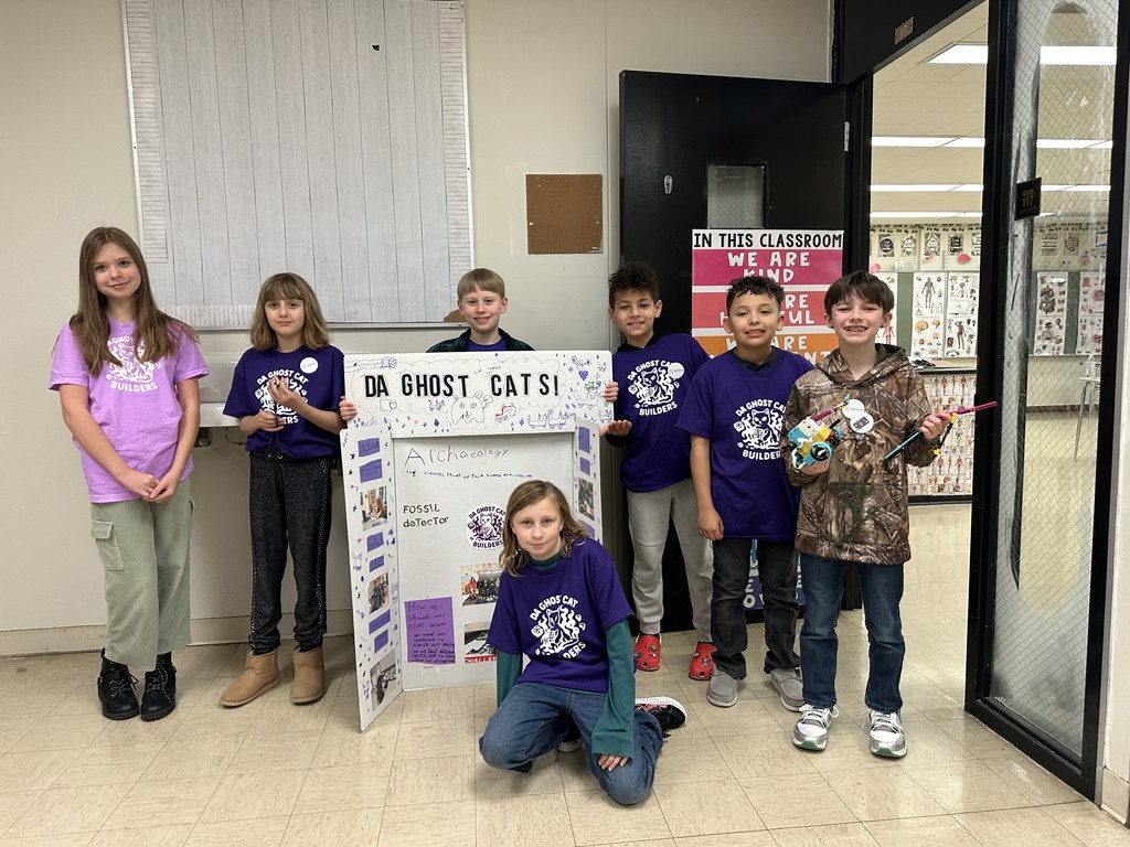 Challenge team in front of their poster board