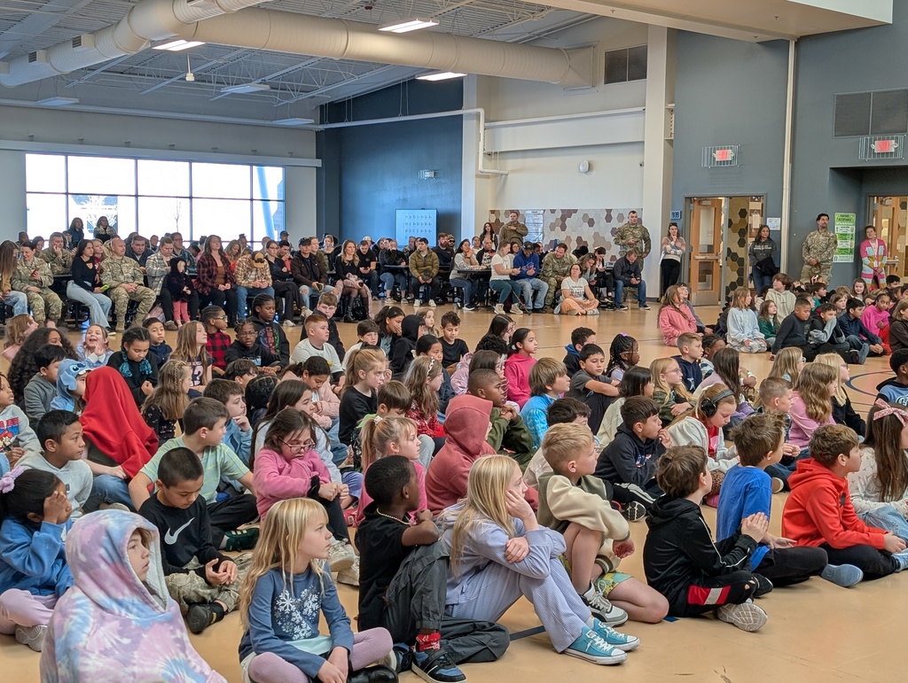 students, parents and guardians attending quarterly awards ceremony