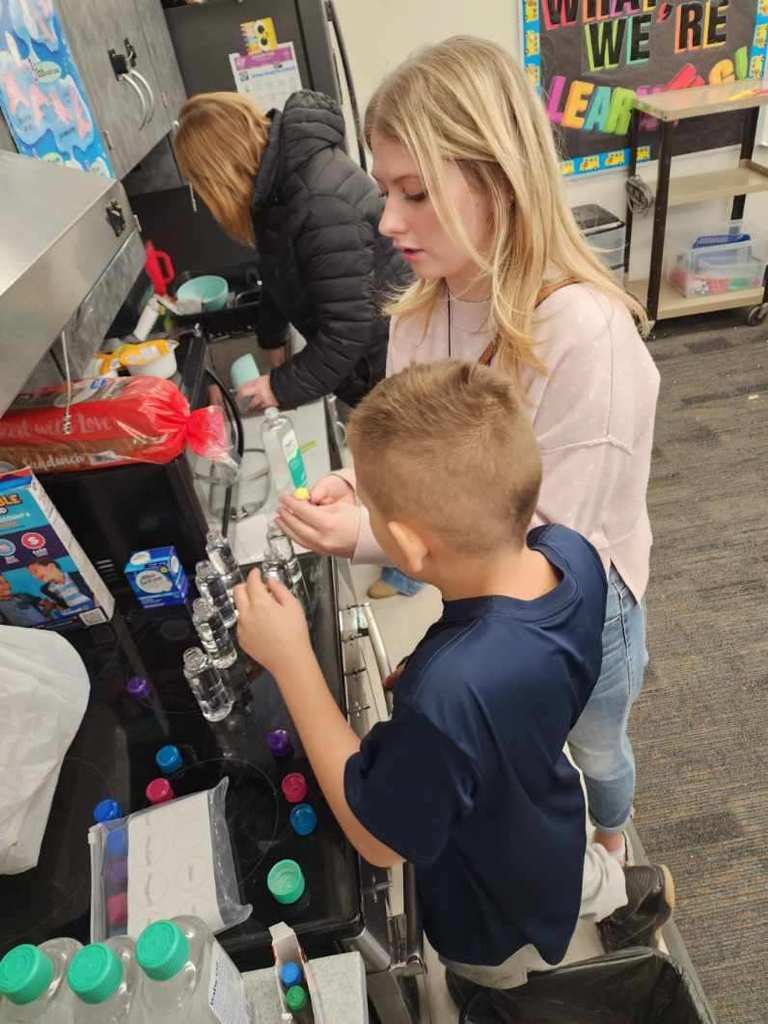 teacher and student making lava lamps