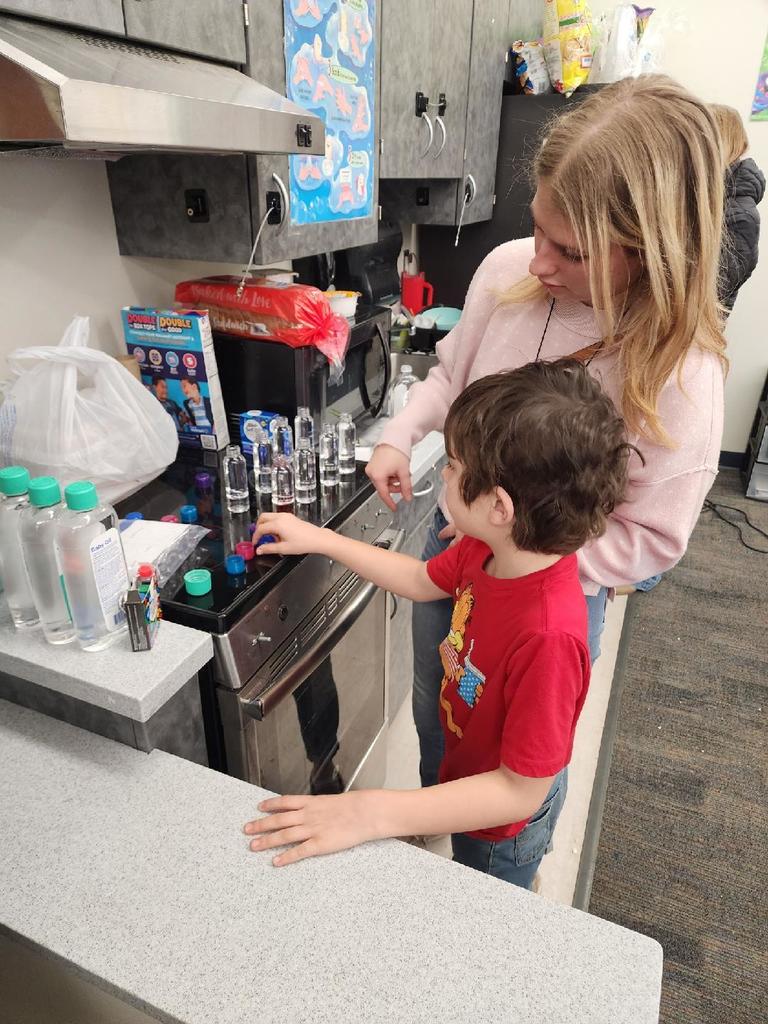 teacher and students making lava lamps