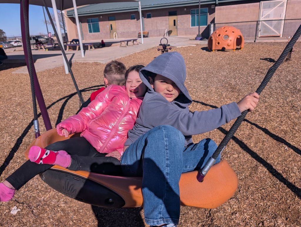 Three of Mrs. V's kids are enjoying a few rays of sunshine on the swing! 