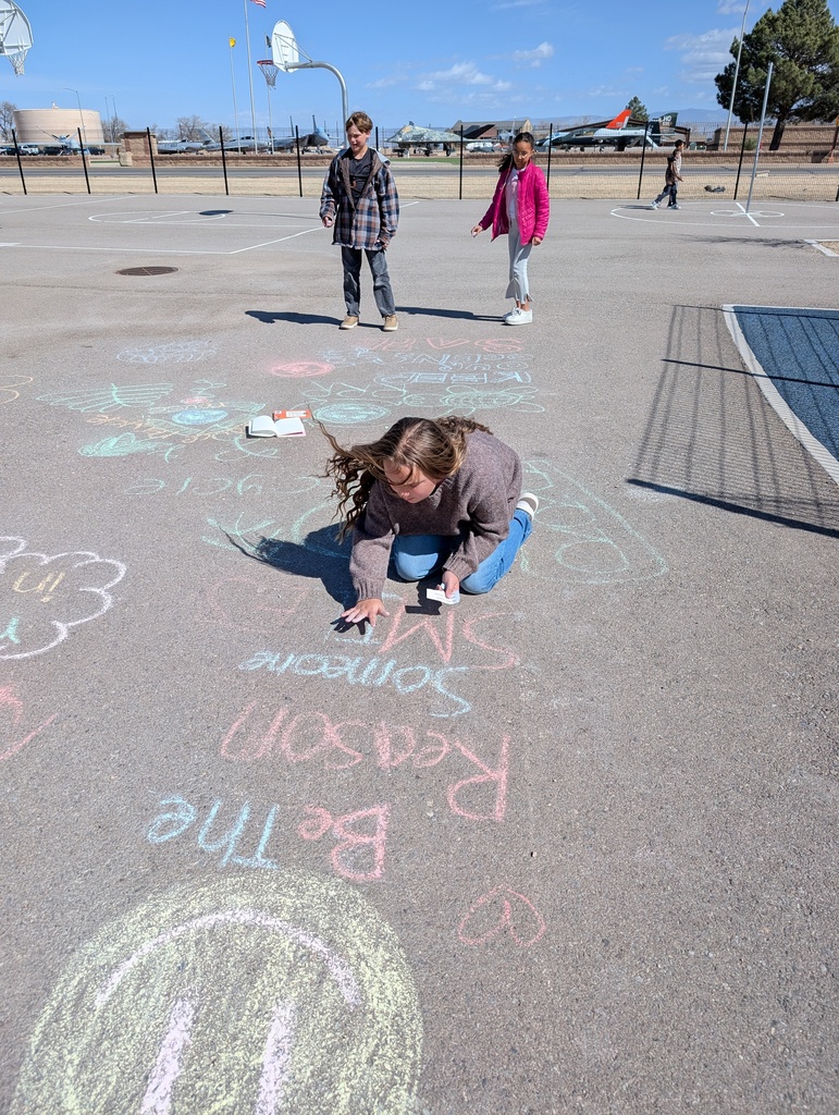 student drawing with chalk