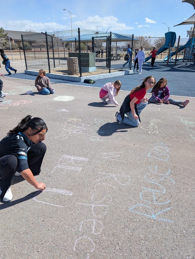 student writting messages with chalk