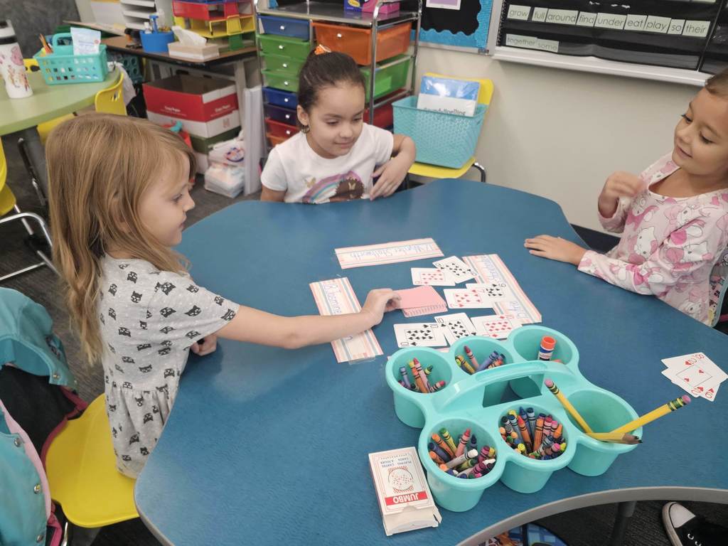 1st grader students with cards