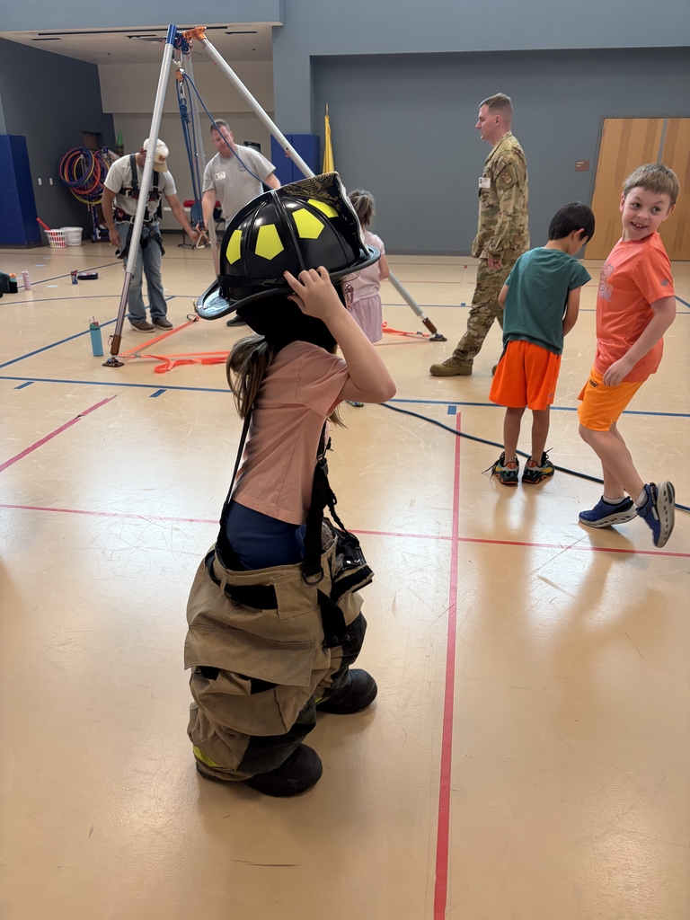 Students trying on firefighter outfits