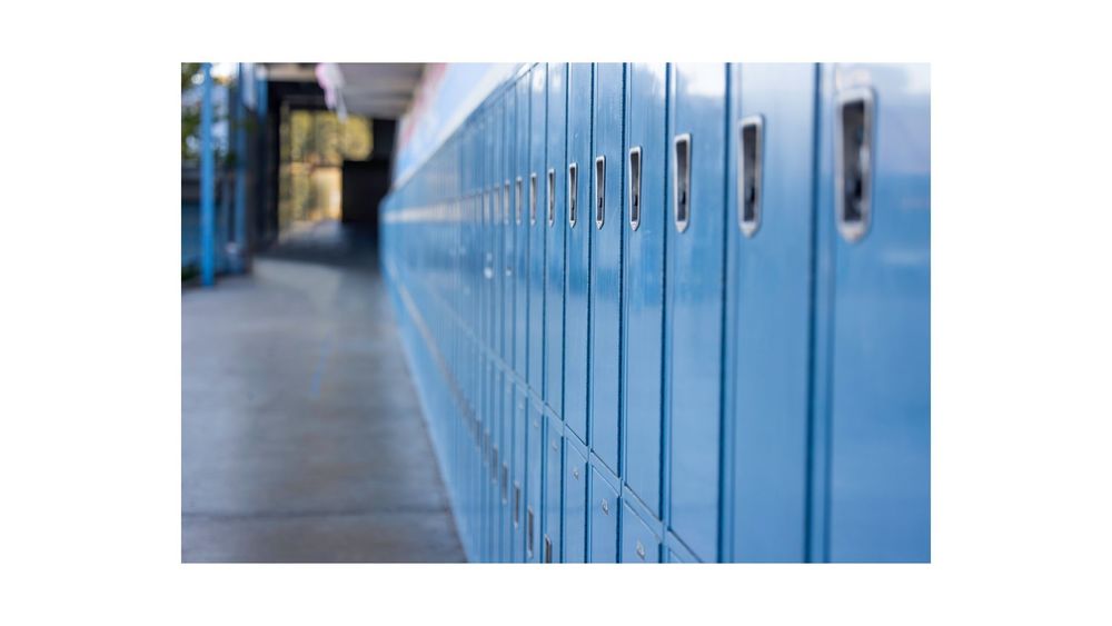 Line of blue lockers down a halway