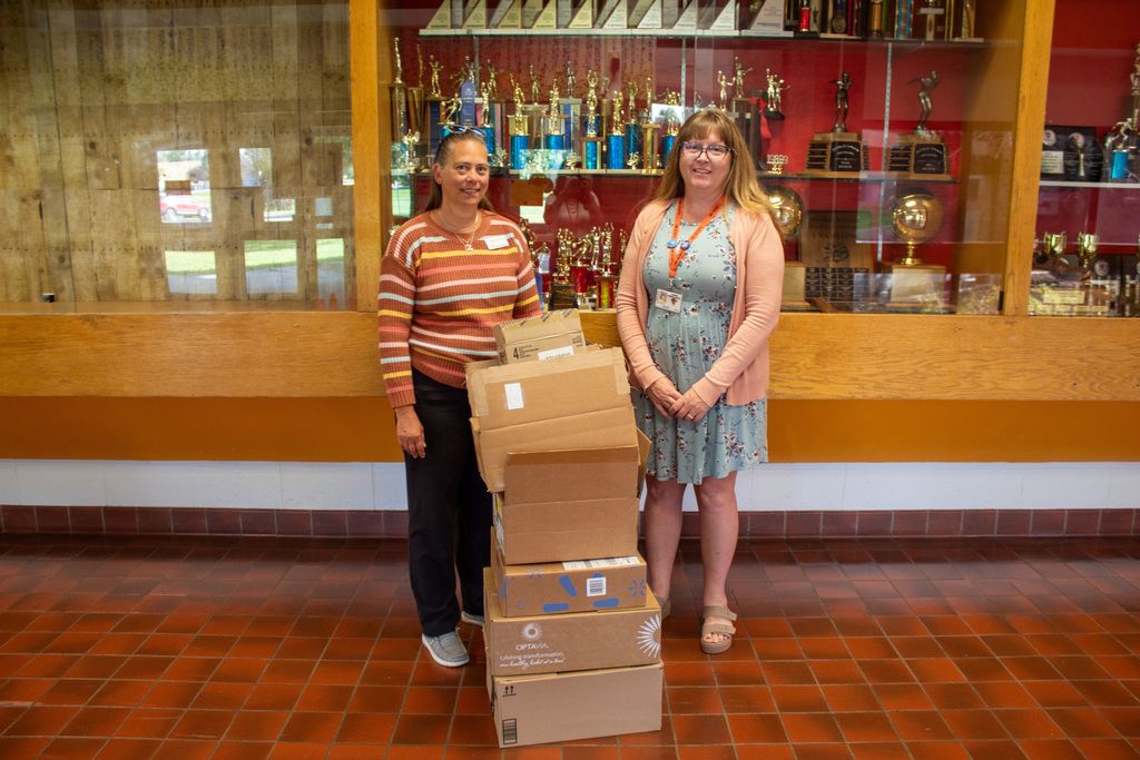 ACSD#1 and First Interstate bank employees gathered around pile of donations