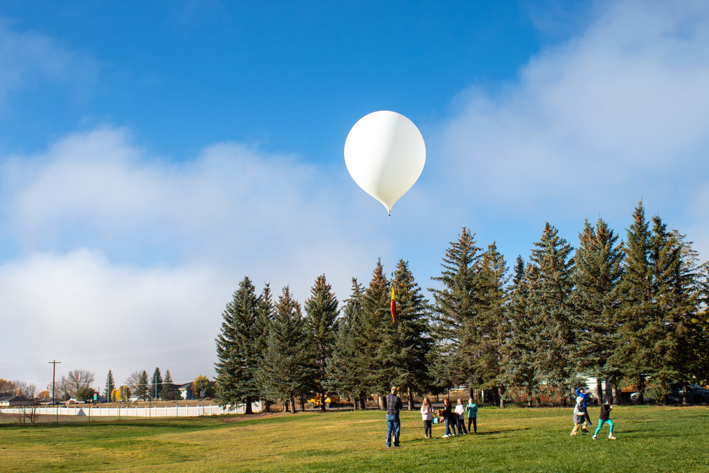 UW staff and Linford students preparing to release the weather balloon