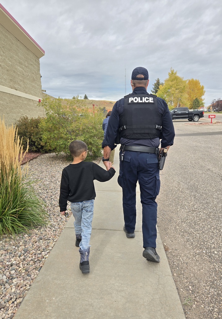 Student walking side by side with an officer