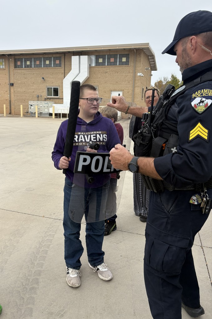 Student learning about police equipment