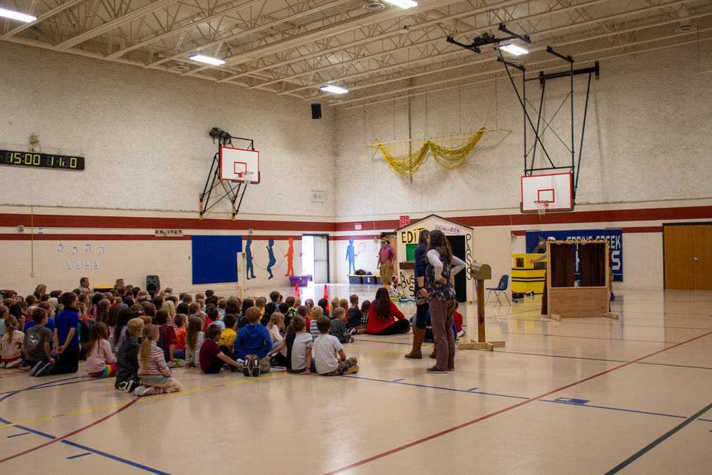Students listening to presentation in the gym