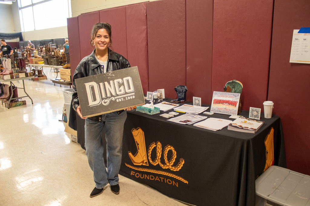 One women posing with their new boots holding their boot box