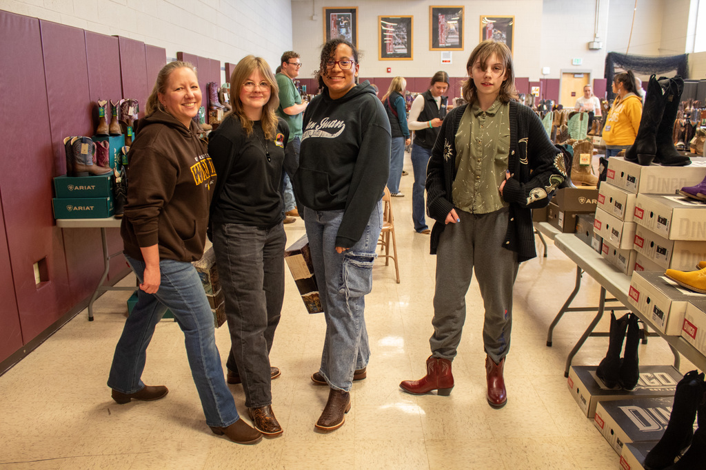 Teachers and students posing with their new boots