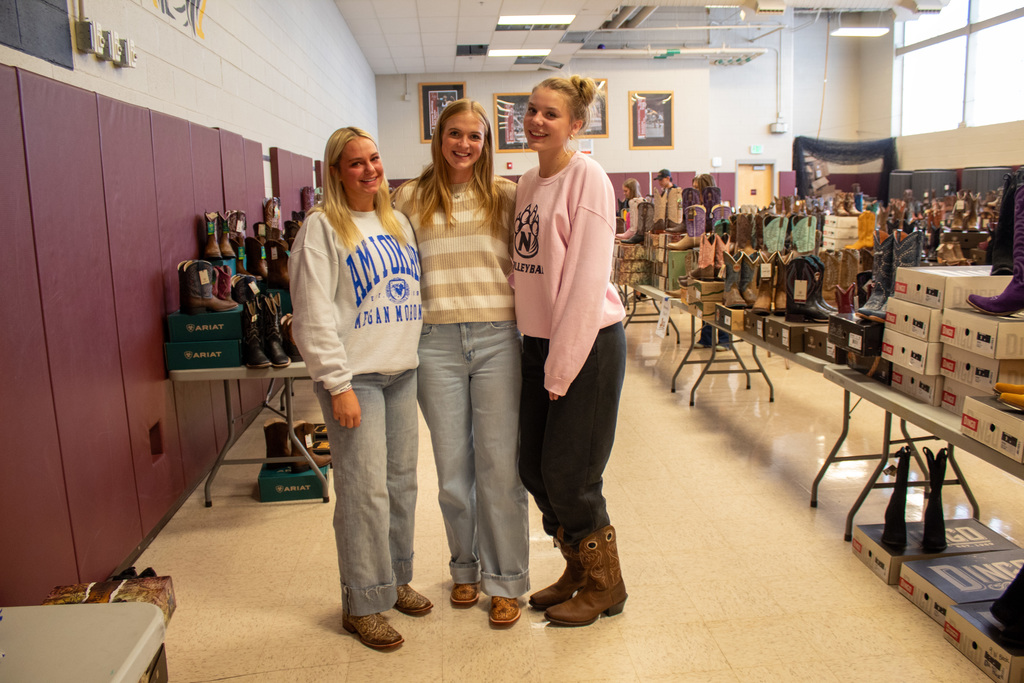 Three women posing with their new boots