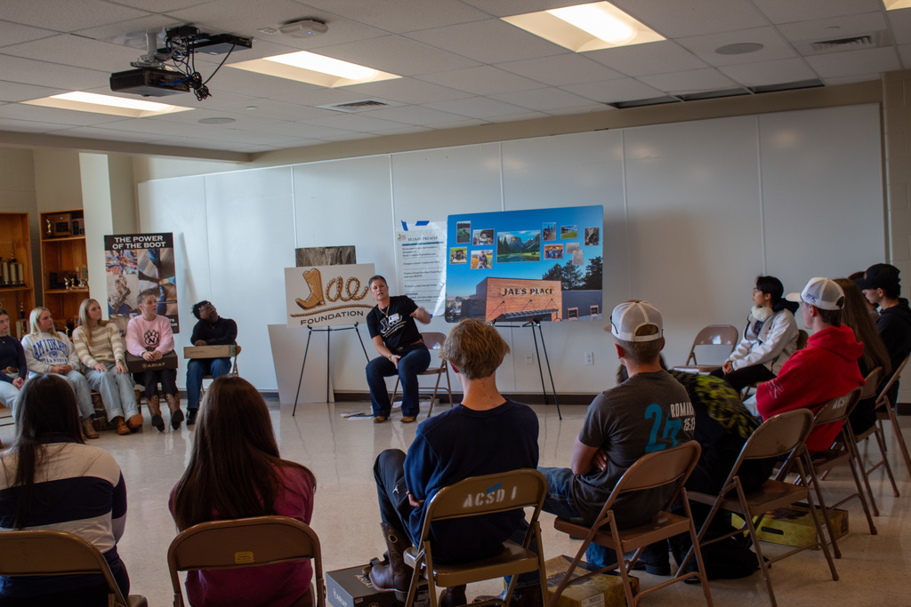 Students sitting in a circle listening to the Jae foundation presentation