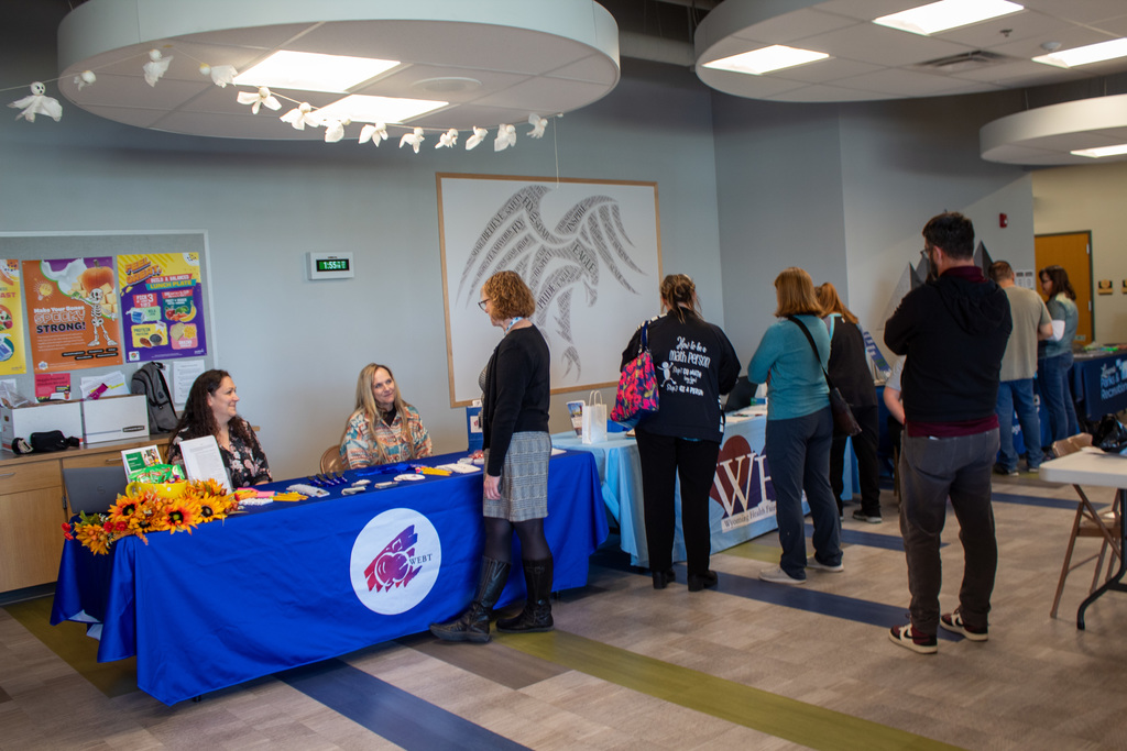 Staff members gathered in front of vendor tables