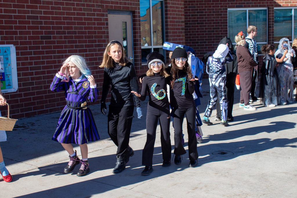 Students dressed up for Halloween, walking in the school Halloween parade