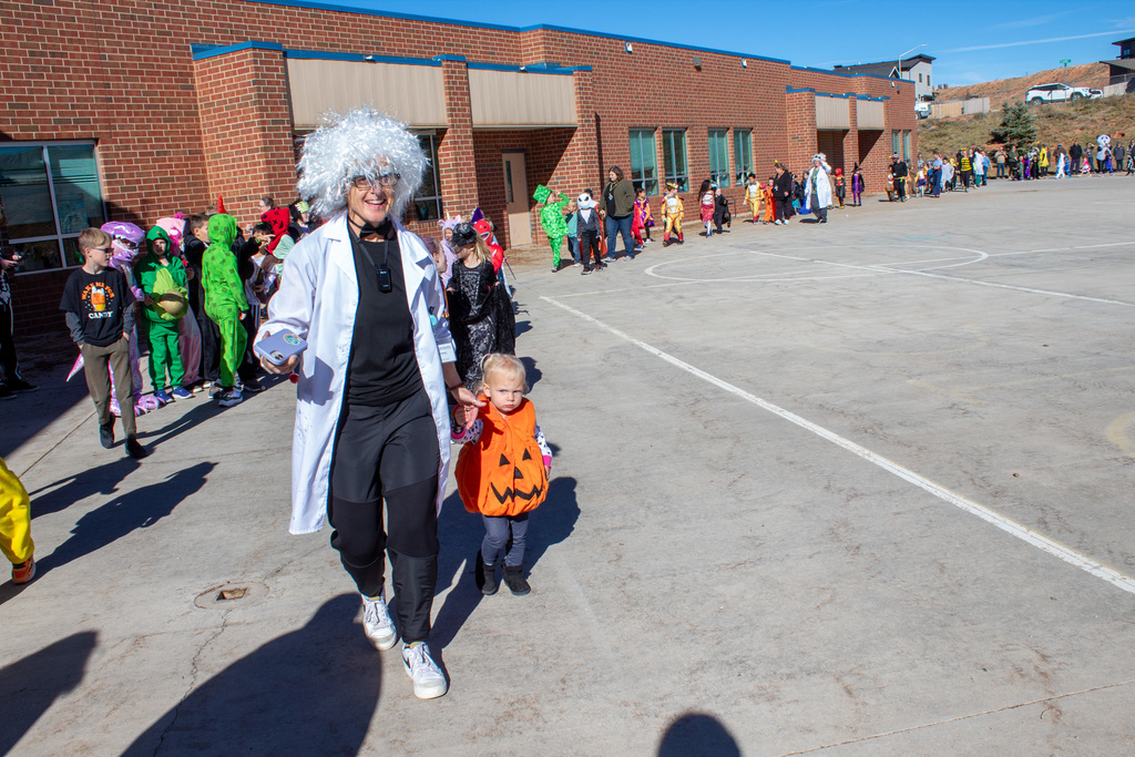 Students dressed up for Halloween, walking in the school Halloween parade