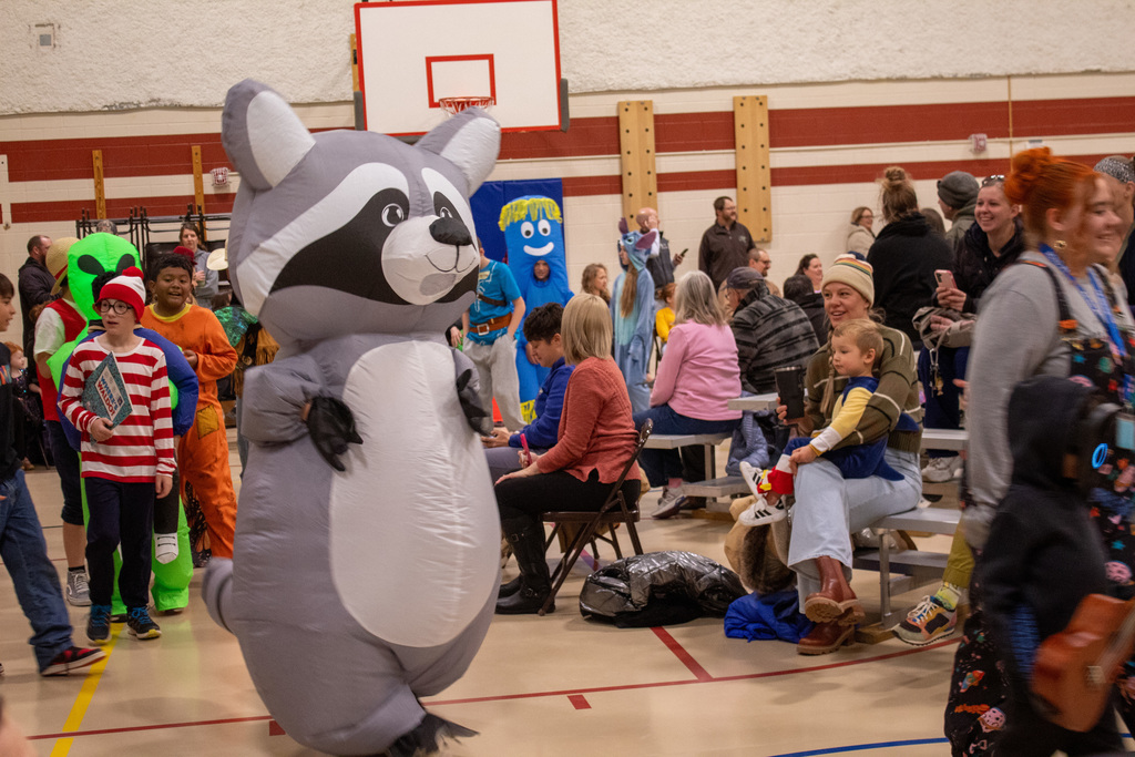 Students dressed up for Halloween, walking in the school Halloween parade