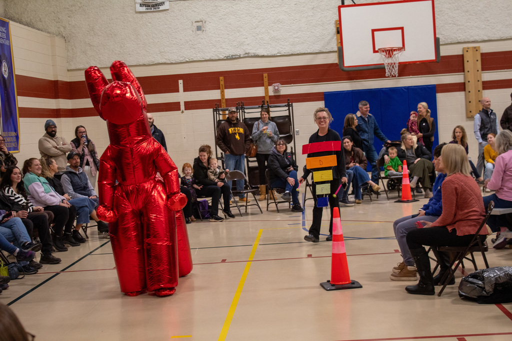 Staff dressed as a balloon animal and musical instrument, walking in the Halloween parade