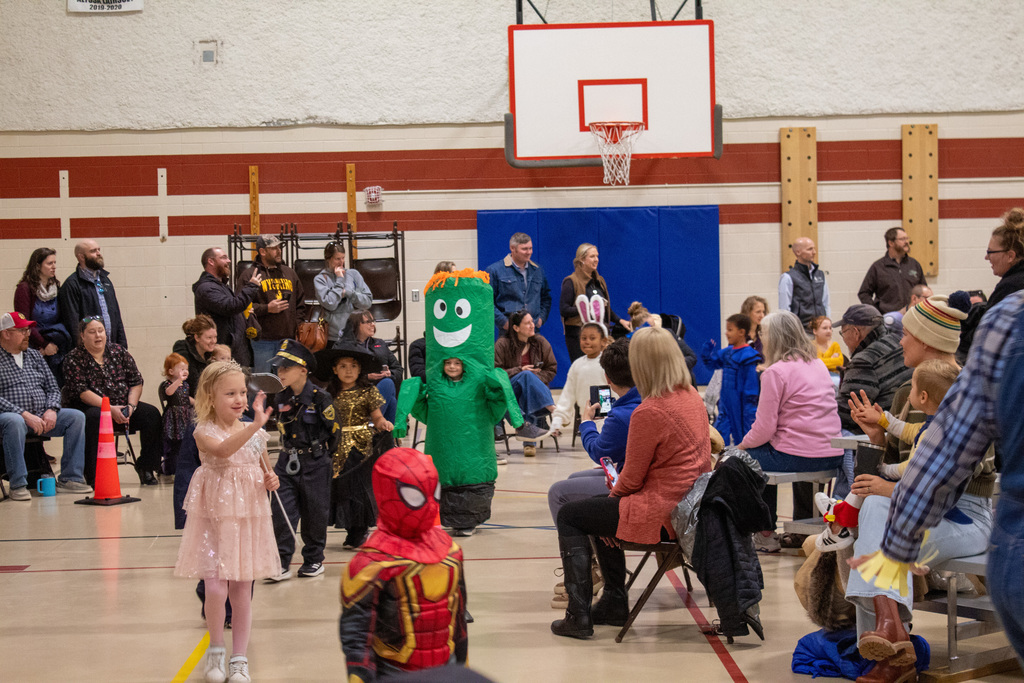 Students dressed up for Halloween, walking in the school Halloween parade